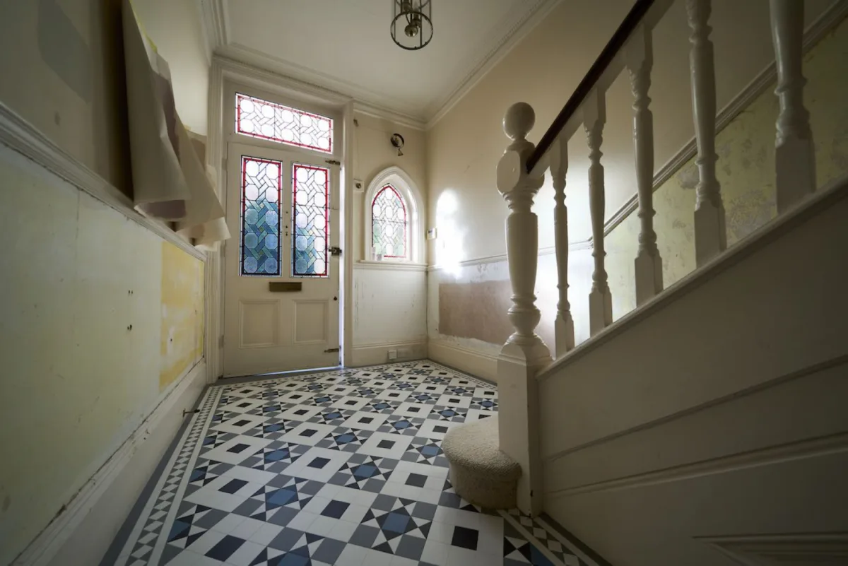 The Crescent Road hallway before: stripped walls and exposed preparation work around the staircase